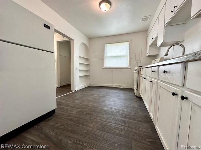 kitchen with white cabinets, dark wood-type flooring, and sink