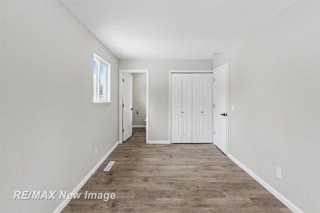 unfurnished bedroom with a closet and light hardwood / wood-style flooring