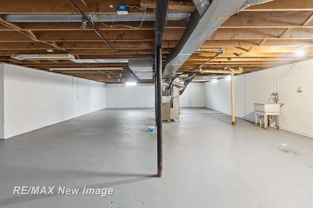 basement featuring heating unit and sink