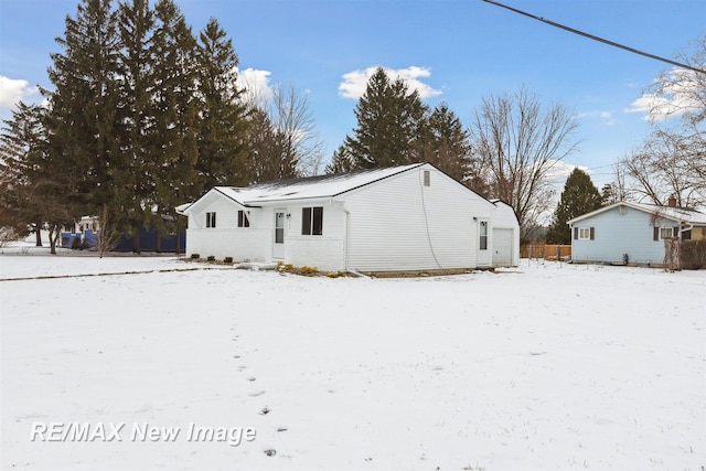 view of snow covered rear of property