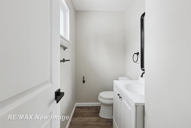 bathroom featuring vanity, toilet, and wood-type flooring