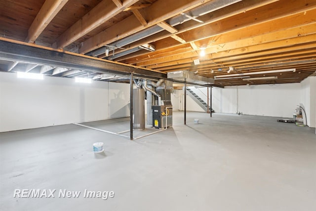 basement featuring heating unit and water heater