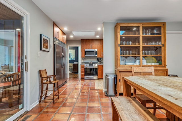 kitchen with light tile patterned flooring and stainless steel appliances