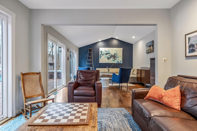 living room featuring wood-type flooring and lofted ceiling