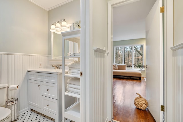 bathroom featuring vanity, toilet, and ornamental molding