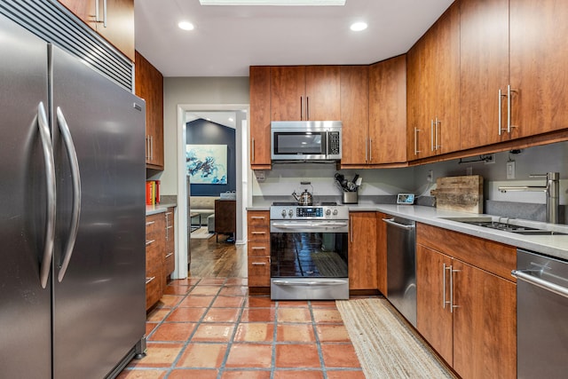 kitchen with light tile patterned floors, sink, and appliances with stainless steel finishes