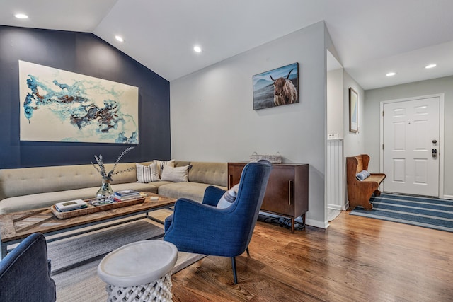 living room featuring hardwood / wood-style floors and lofted ceiling