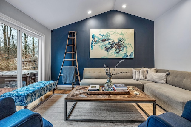 living room featuring wood-type flooring and vaulted ceiling