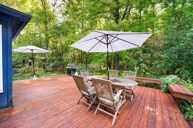 wooden deck featuring a grill