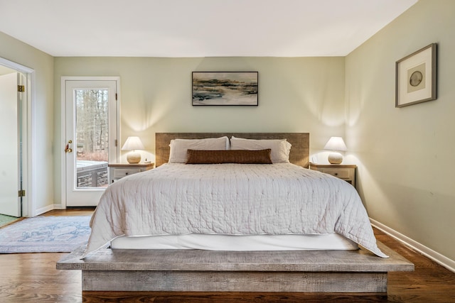 bedroom with access to exterior and hardwood / wood-style flooring