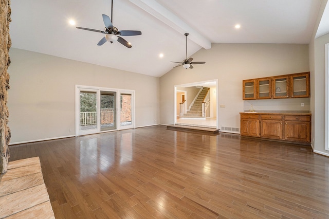 unfurnished living room with ceiling fan, beamed ceiling, dark wood-type flooring, and high vaulted ceiling