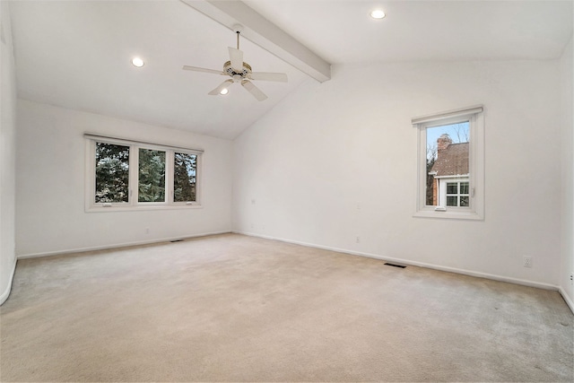 carpeted spare room featuring vaulted ceiling with beams and ceiling fan