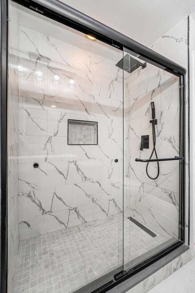 bathroom with a shower with shower door