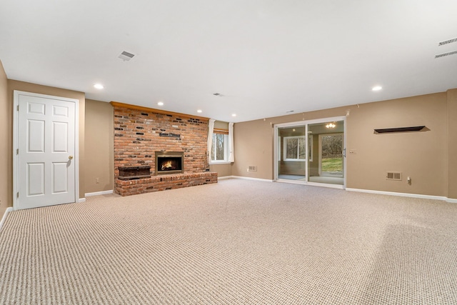 unfurnished living room with light colored carpet and a brick fireplace