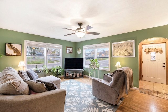 living room featuring ceiling fan and light hardwood / wood-style flooring