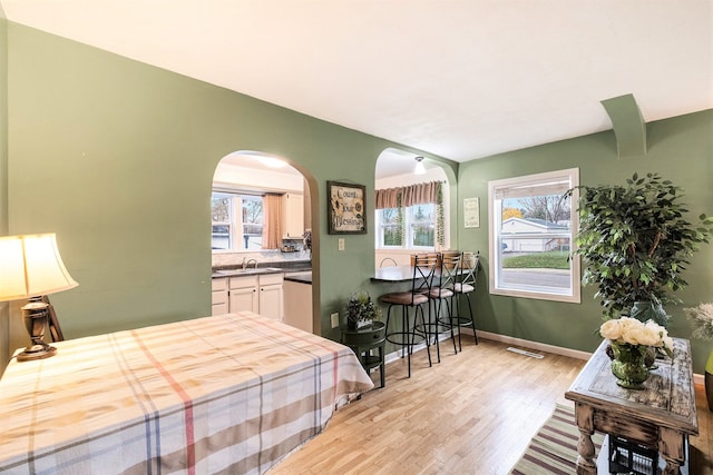 bedroom with light hardwood / wood-style flooring and sink