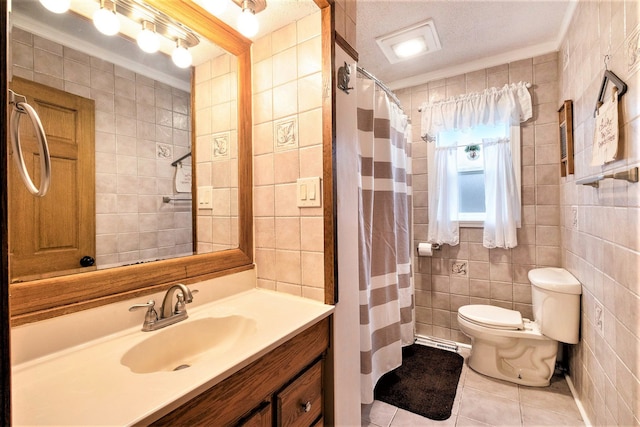 bathroom featuring tile patterned floors, crown molding, tile walls, and a textured ceiling