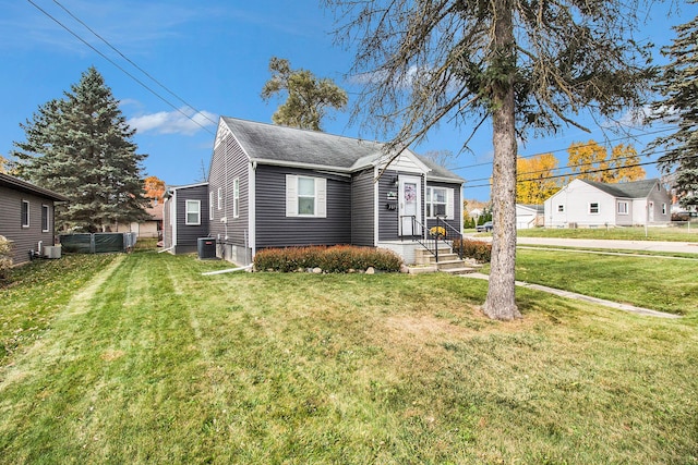 view of front of home with a front lawn and cooling unit