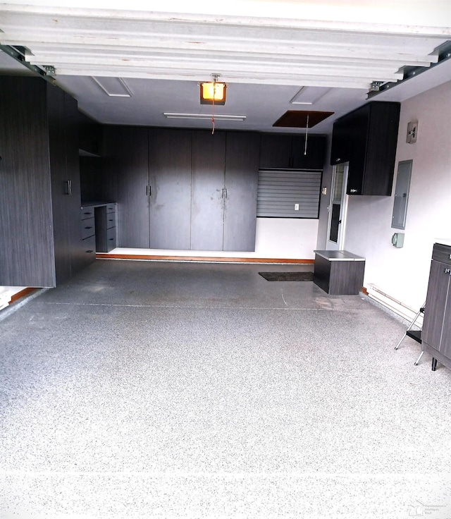 garage with electric panel and a garage door opener