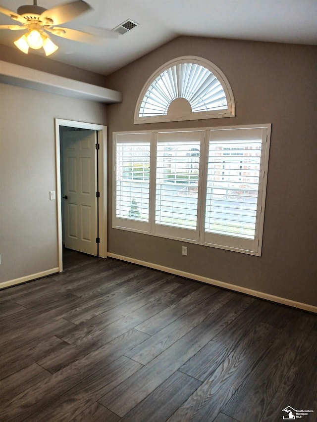 spare room featuring a wealth of natural light, dark hardwood / wood-style flooring, and ceiling fan