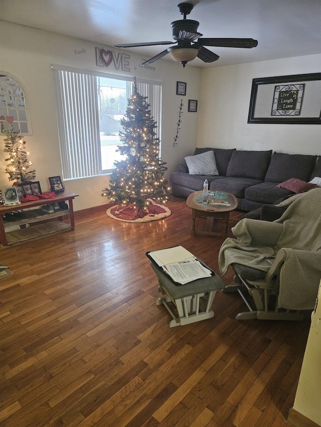 living room featuring ceiling fan and dark hardwood / wood-style flooring