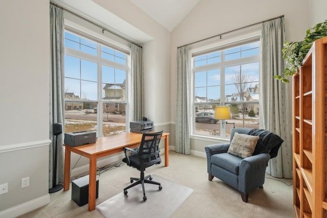 office space with light carpet and lofted ceiling