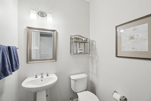 bathroom featuring toilet and sink