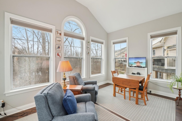 sunroom featuring plenty of natural light and lofted ceiling