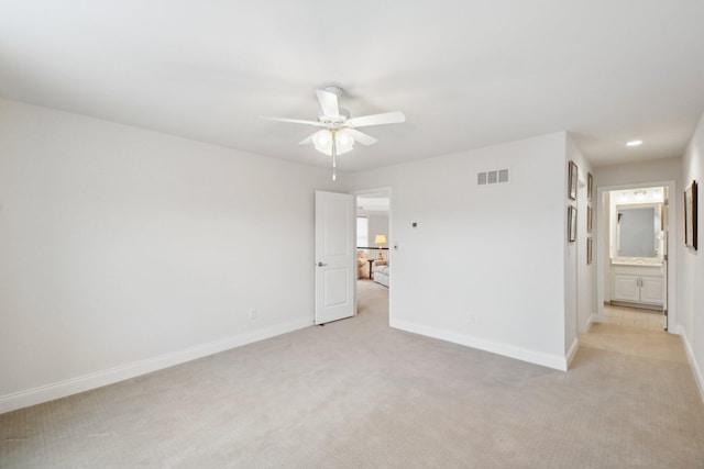 carpeted spare room with ceiling fan