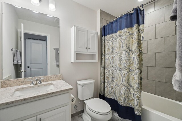 full bathroom featuring shower / bath combo with shower curtain, vanity, and toilet