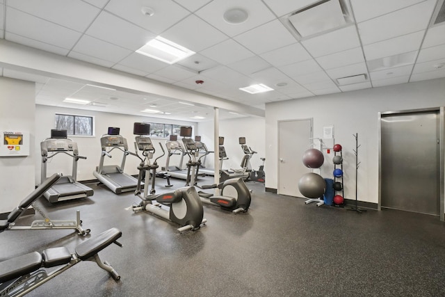 workout area with a paneled ceiling