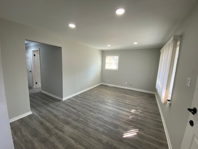 empty room with dark wood-type flooring