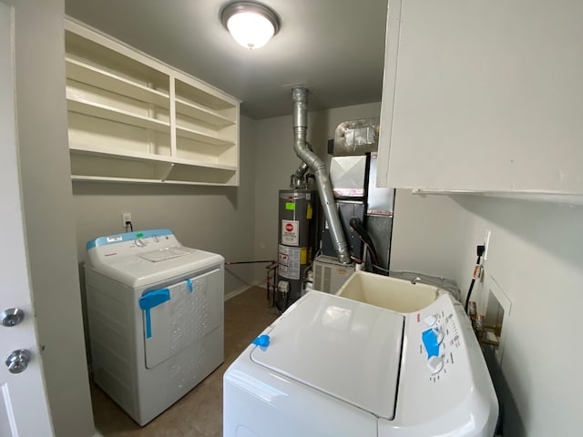 laundry area with gas water heater, sink, and washing machine and clothes dryer