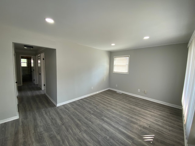 empty room with dark hardwood / wood-style floors