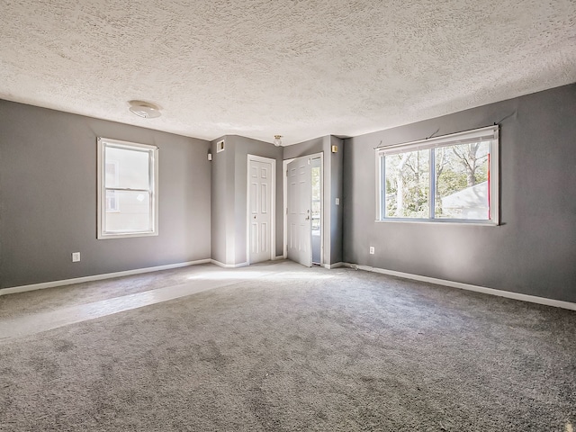 unfurnished bedroom featuring a textured ceiling and carpet floors