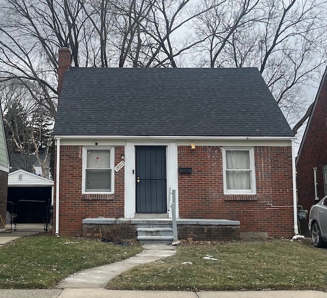 bungalow-style home featuring a front yard