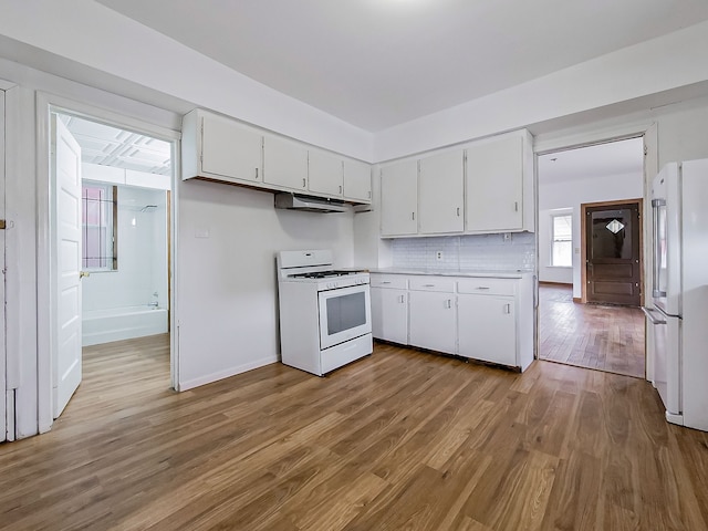 kitchen with white cabinetry, white appliances, backsplash, and light hardwood / wood-style flooring