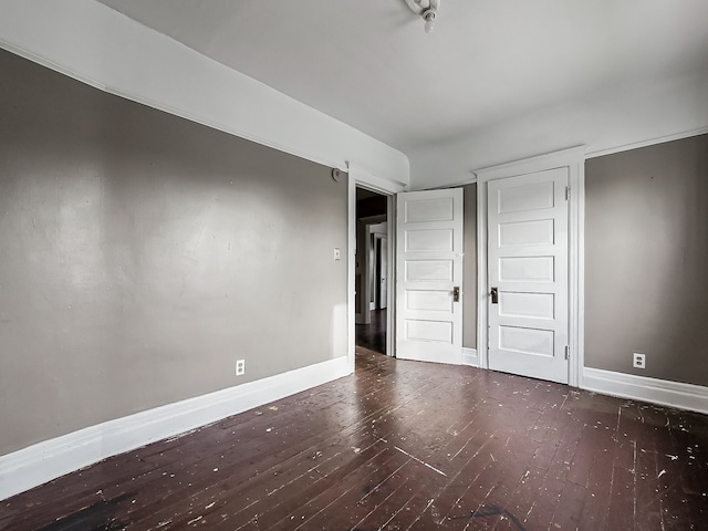 unfurnished bedroom featuring dark hardwood / wood-style flooring