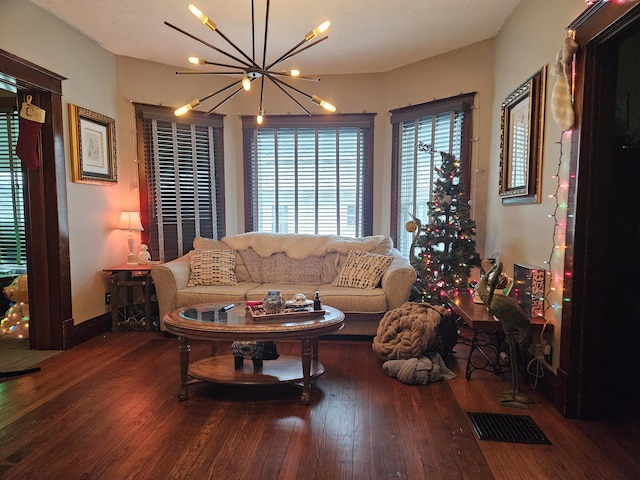 living room featuring hardwood / wood-style flooring and a notable chandelier