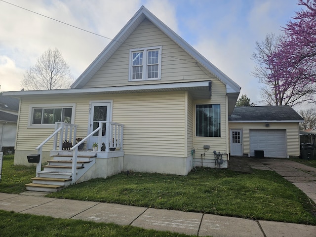 103 E Maple St, Three Oaks, MI 49128 - bungalow-style house with driveway, a front yard, and an attached garage