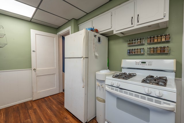 kitchen featuring dark wood-type flooring, white appliances, white cabinets, and a paneled ceiling