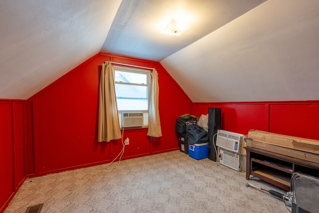 bonus room with an AC wall unit, cooling unit, light carpet, and lofted ceiling