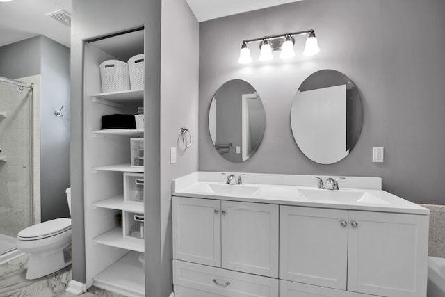 bathroom featuring vanity, a shower with shower door, and toilet