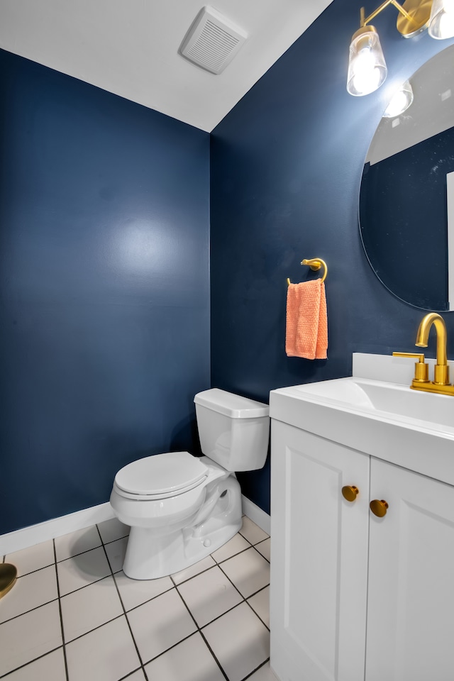 bathroom featuring tile patterned floors, vanity, and toilet