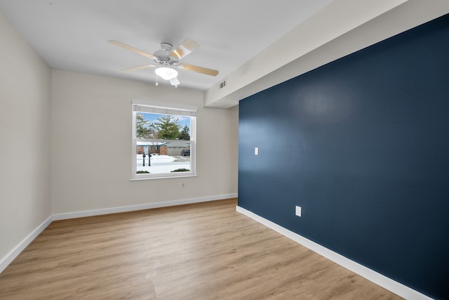 spare room with light hardwood / wood-style floors and ceiling fan