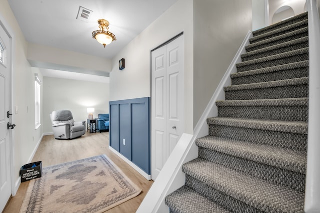 stairway with hardwood / wood-style floors