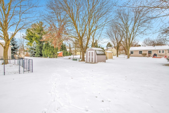 snowy yard with a shed