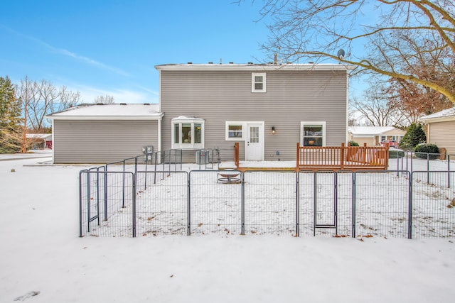 snow covered rear of property featuring a wooden deck