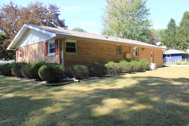 view of side of property featuring a yard