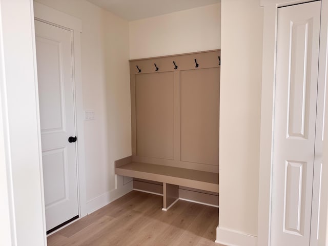 mudroom featuring baseboards and light wood-type flooring